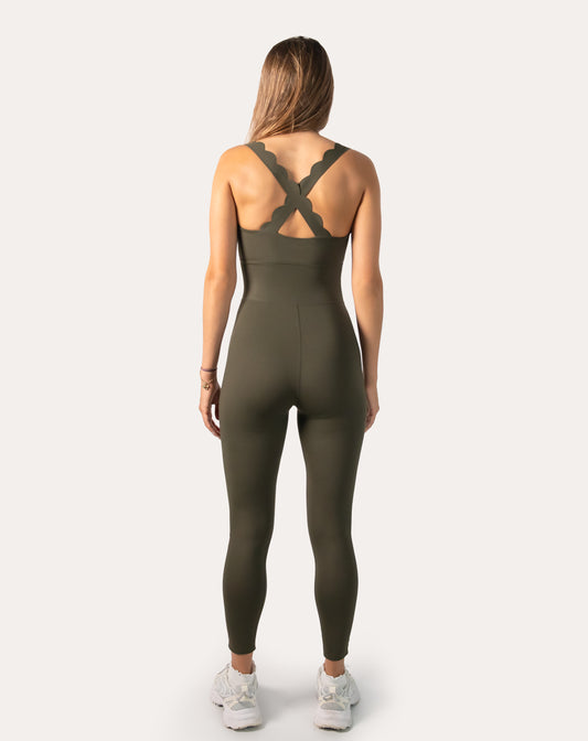 Back view of olive athletic jumpsuit for women with cross-back straps and fitted waist