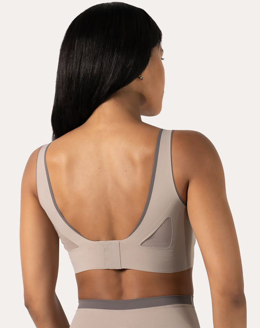 Back view of beige high impact sports bra with mesh U-back and hook-back closure
