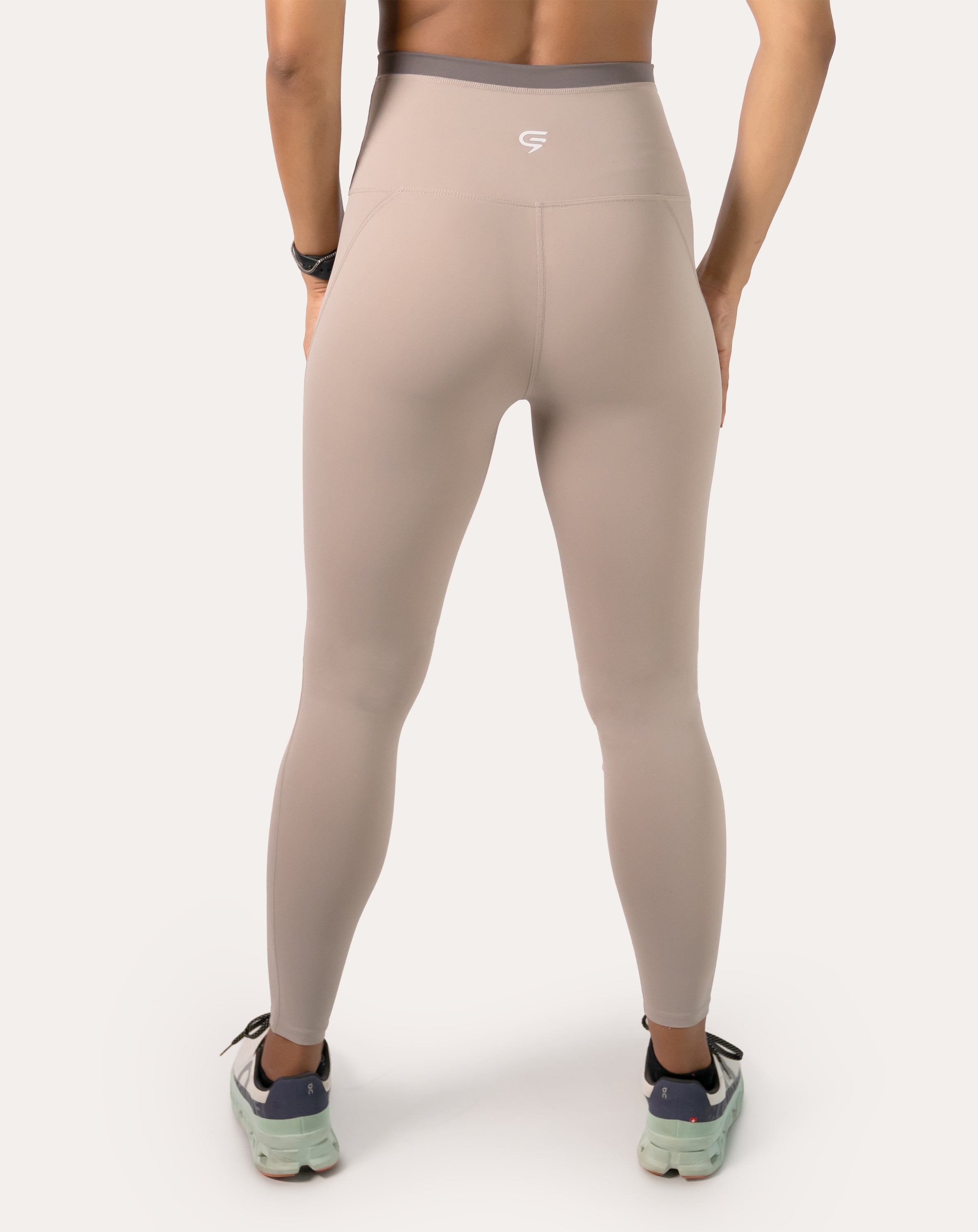 Back close-up of beige leggings showing the high-waist band, gusset, and smooth seams