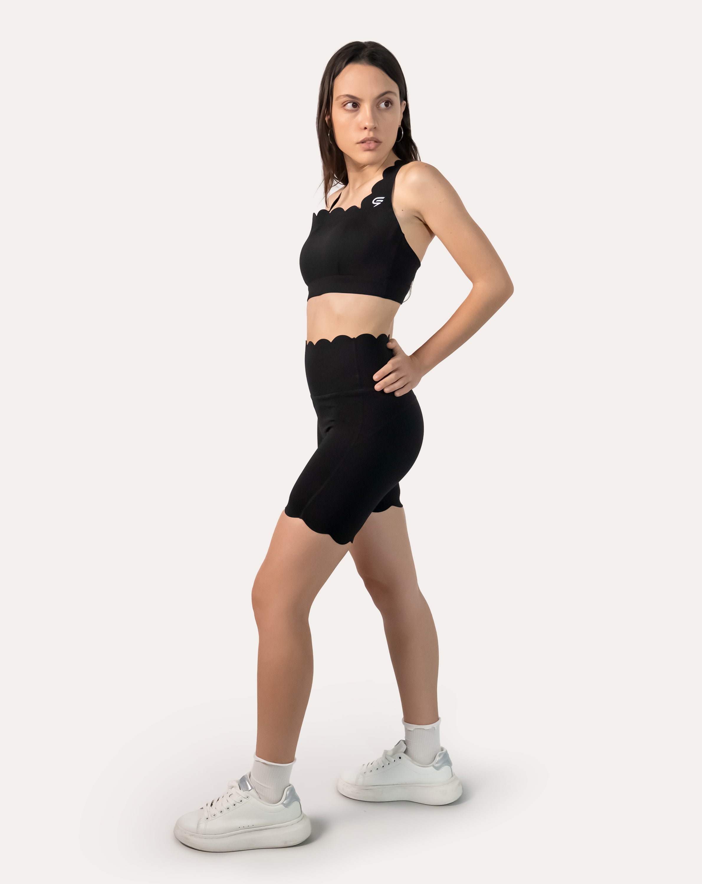 Side profile of black gym shorts set with seamless longline bra and high-waist shorts
