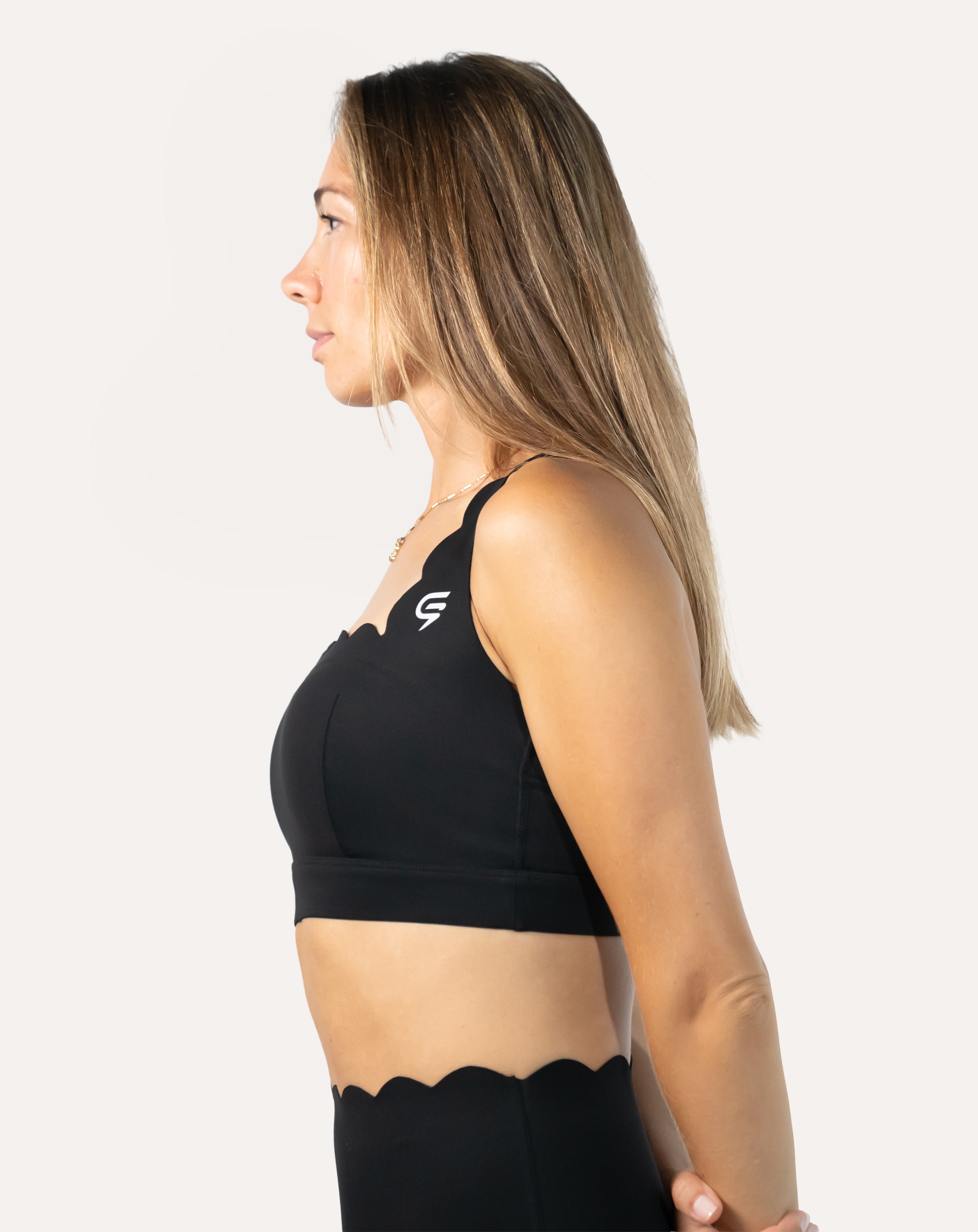 Right side profile of black padded sports bra showing smooth knit and supportive underband