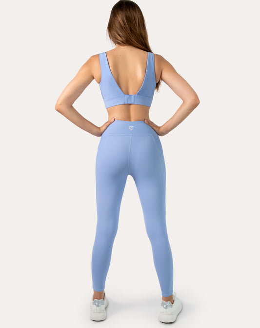 Back view of blue gym set highlighting supportive straps and wide waistband
