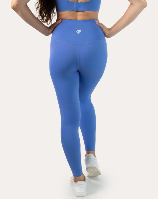 Back view of high-waisted cobalt blue leggings with small rear logo; squat-proof, ankle length