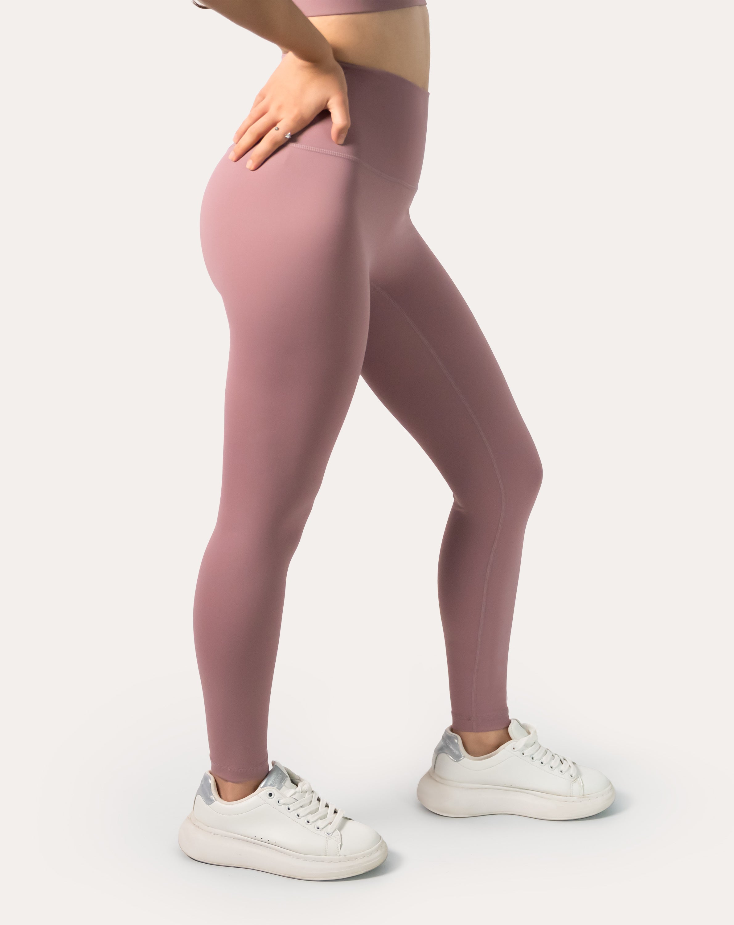 Side view showing sculpt fit, low-chafe seams, and buttery-soft feel of women’s mauve high-waisted leggings