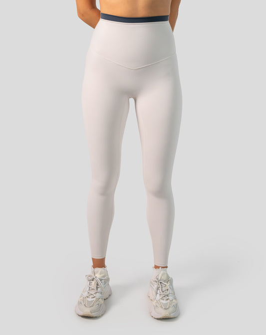 Full-body front view of cream leggings showing smooth, high-waist fit.
