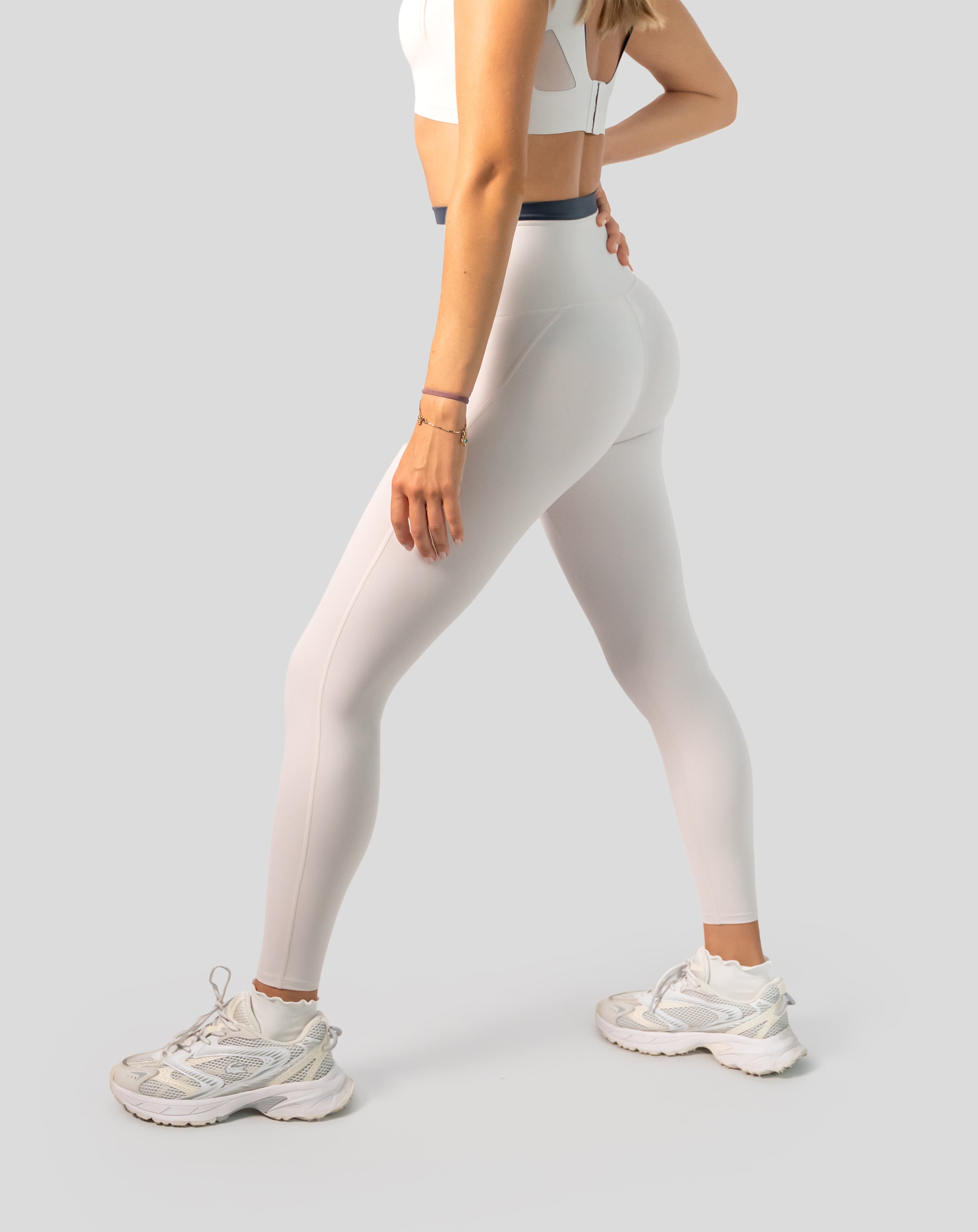 Right side close-up of cream leggings highlighting high-waist and sleek seams