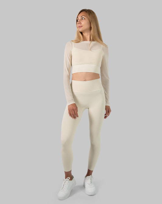 Front view of cream long sleeve gym set; mesh crop layered over crop and high waist leggings