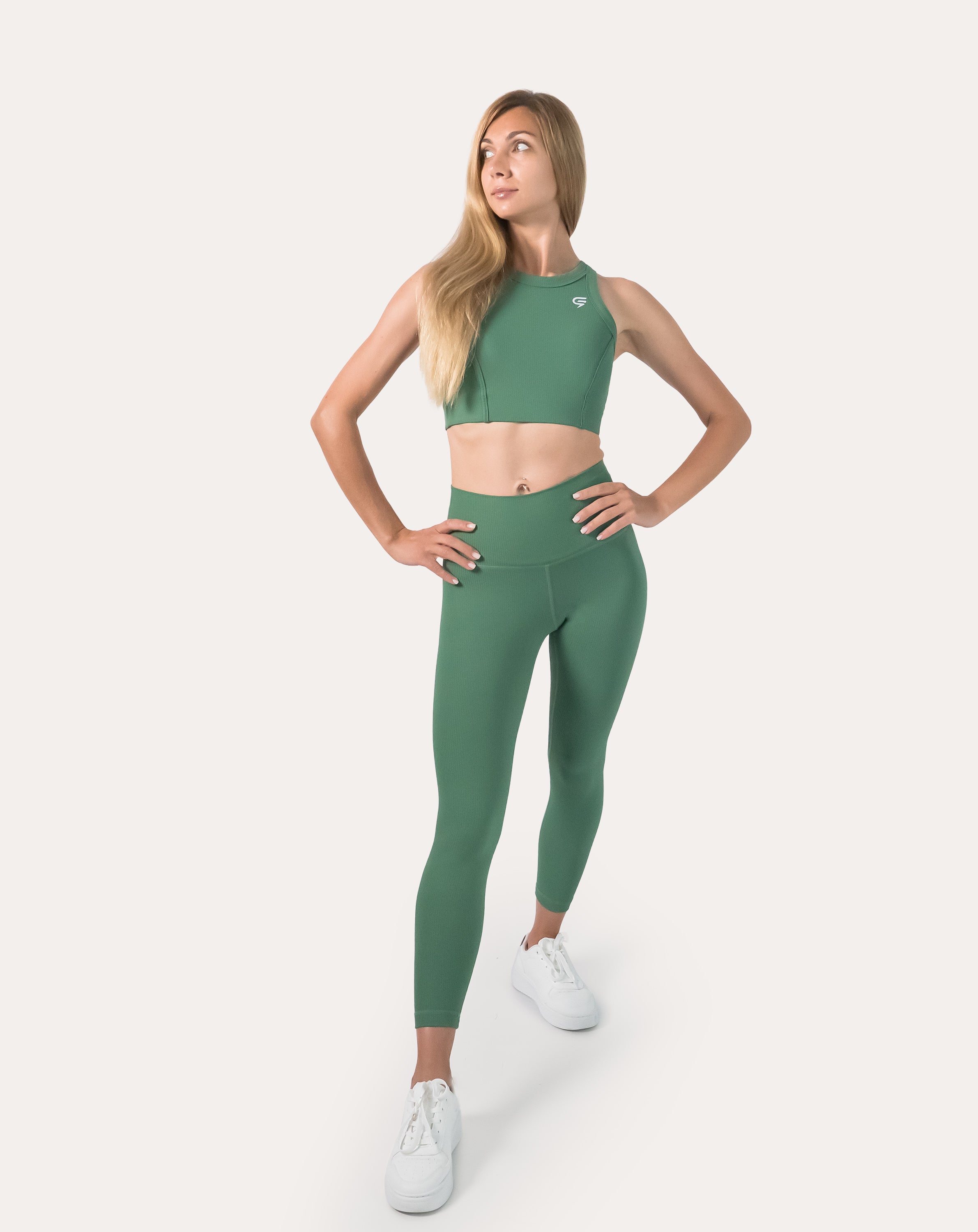 Three-quarter front view of matching set featuring women’s ribbed leggings in green; seamless, supportive high-waist