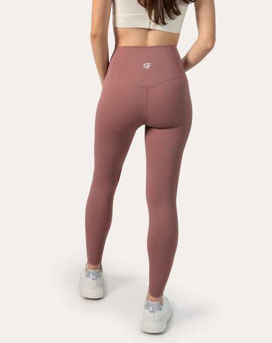Back view showing the high-rise waistband and contour seam on women’s rose-clay high-waisted leggings; squat-proof coverage