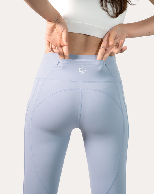Back view highlighting the rear waistband stash pocket on ice blue leggings with phone pocket