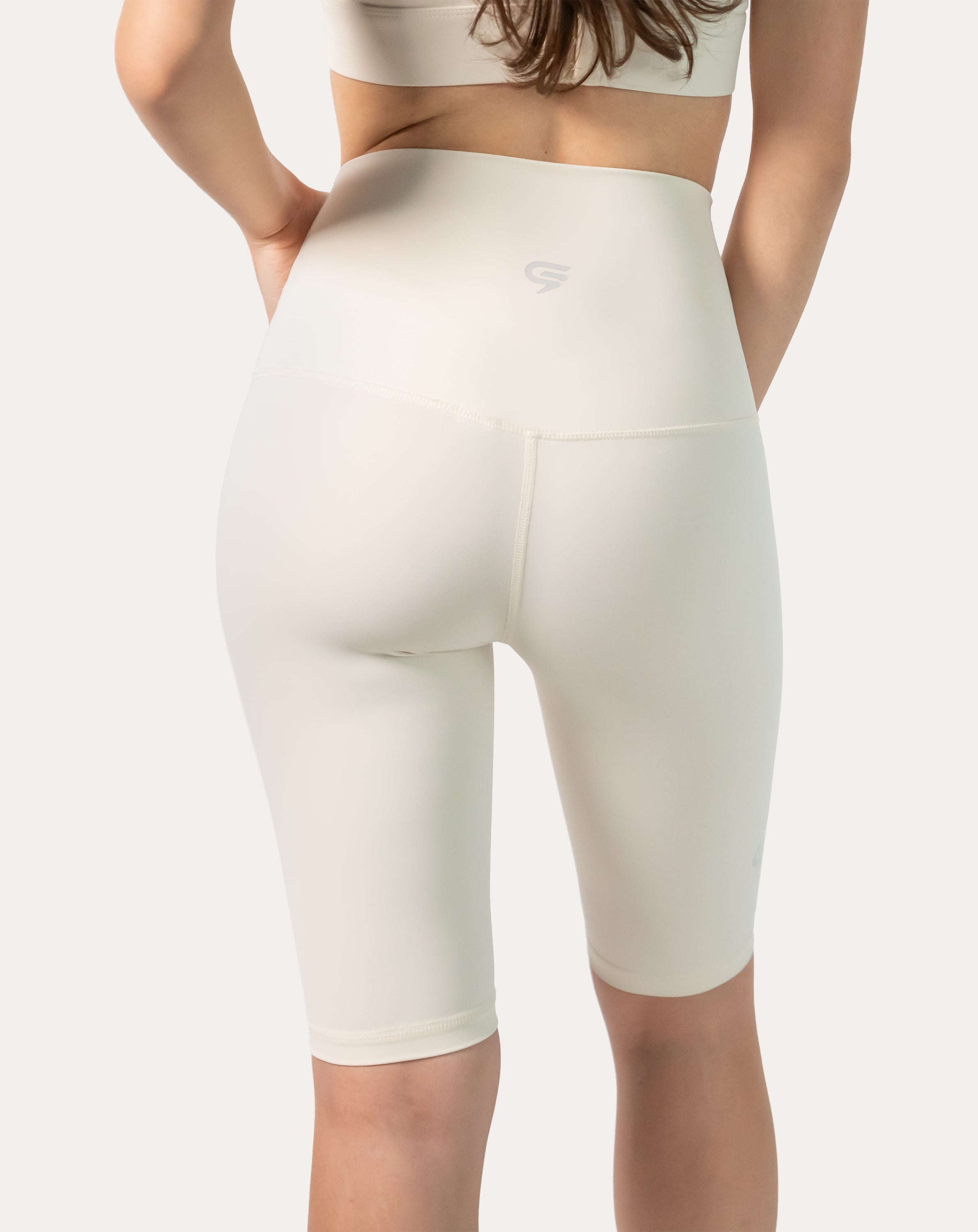 Back three-quarter right view of ivory longline bike shorts with supportive waistband