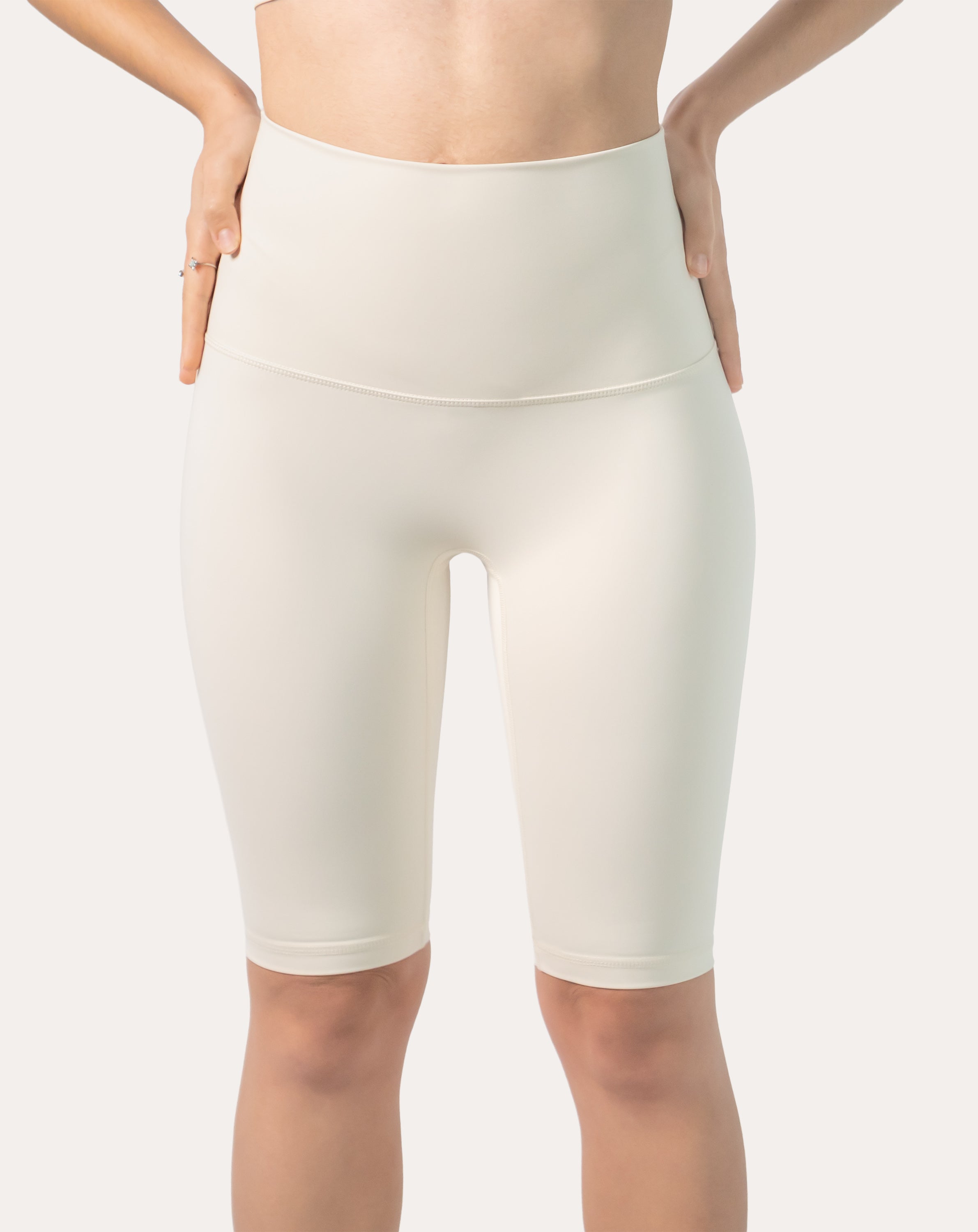Front view of ivory high-waist longline bike shorts with smooth, opaque coverage.