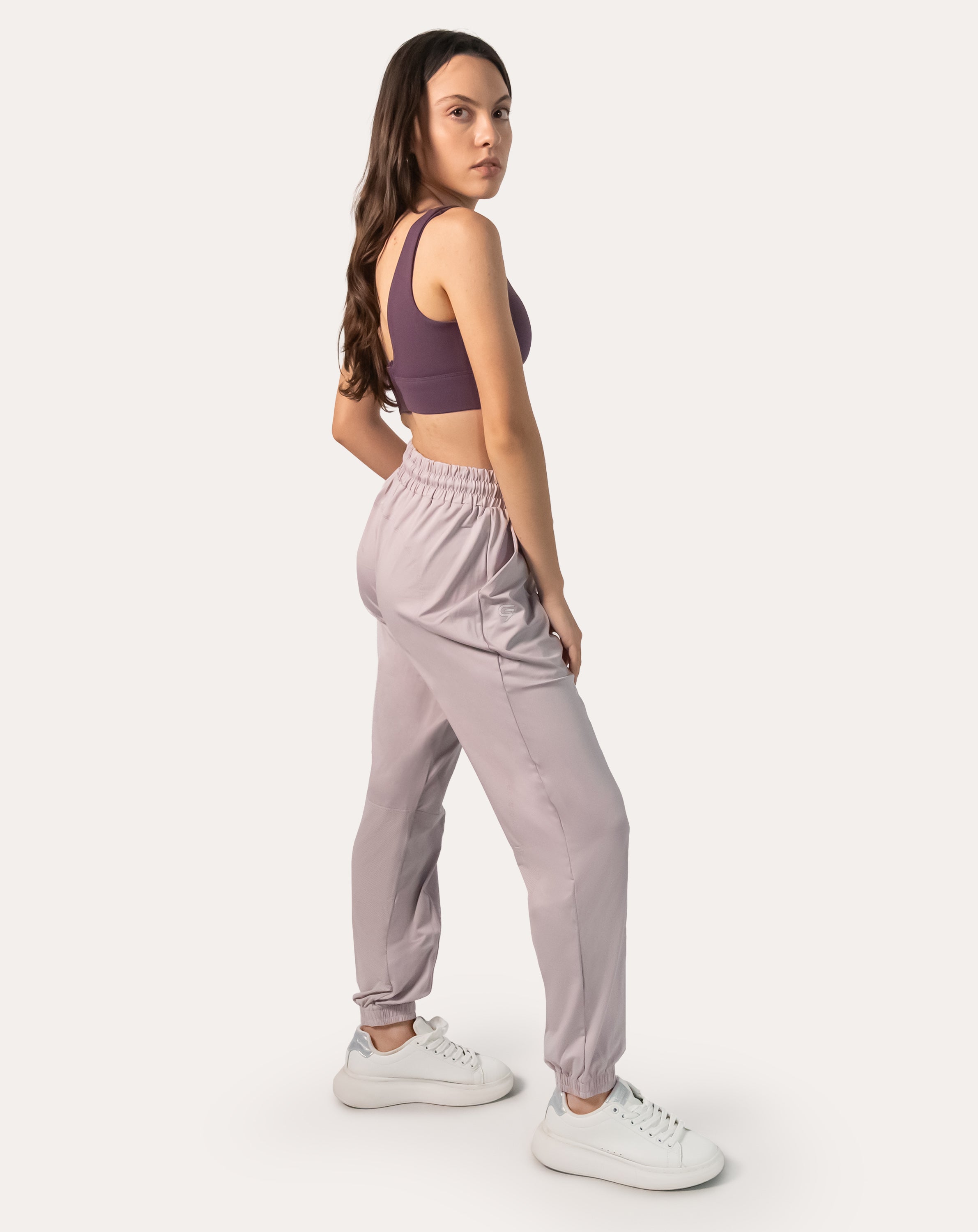 Lilac joggers for women, left three-quarter full-length stance with elastic cuffs