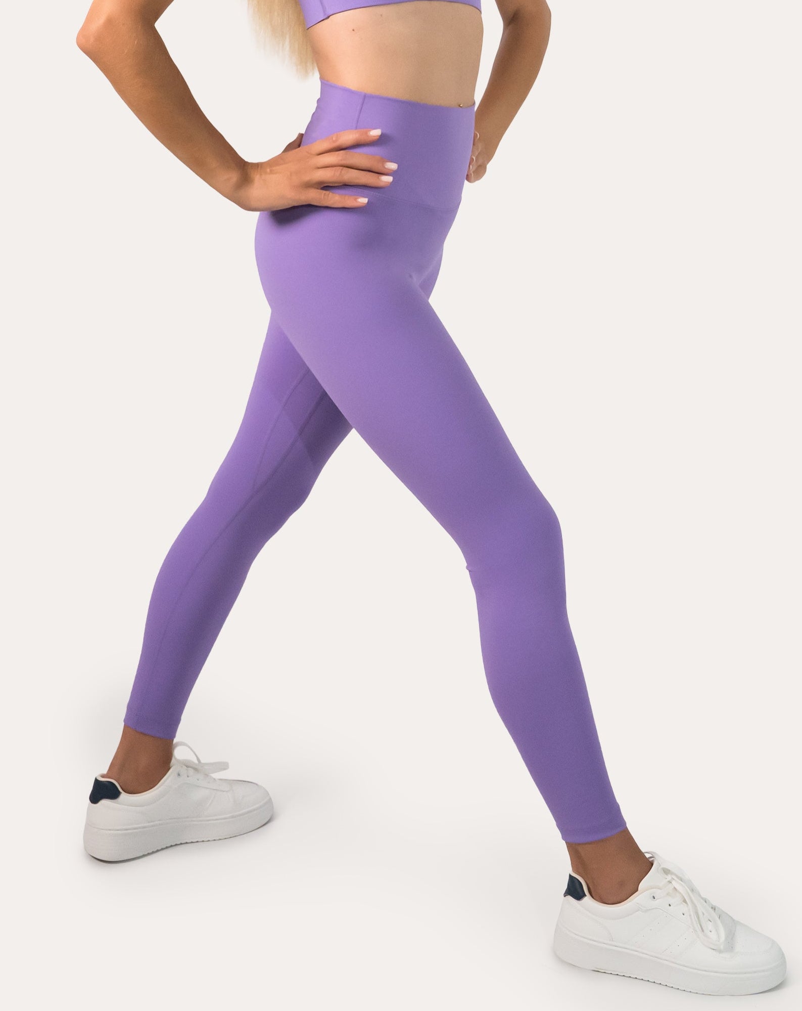 Lilac Pilates leggings with high-waist; side three quarter view in a lunge stance