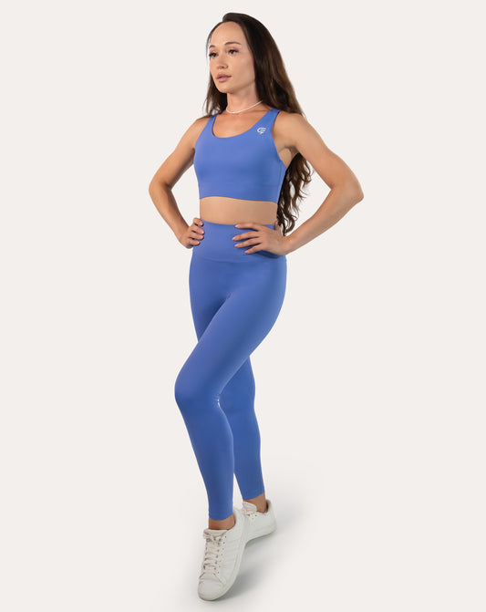 Sapphire blue matching gym set in three-quarter front pose showing longline bra and leggings fit