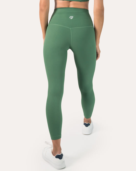 Back view showing contour seams and wide high-waist band on women’s seamless green ribbed leggings