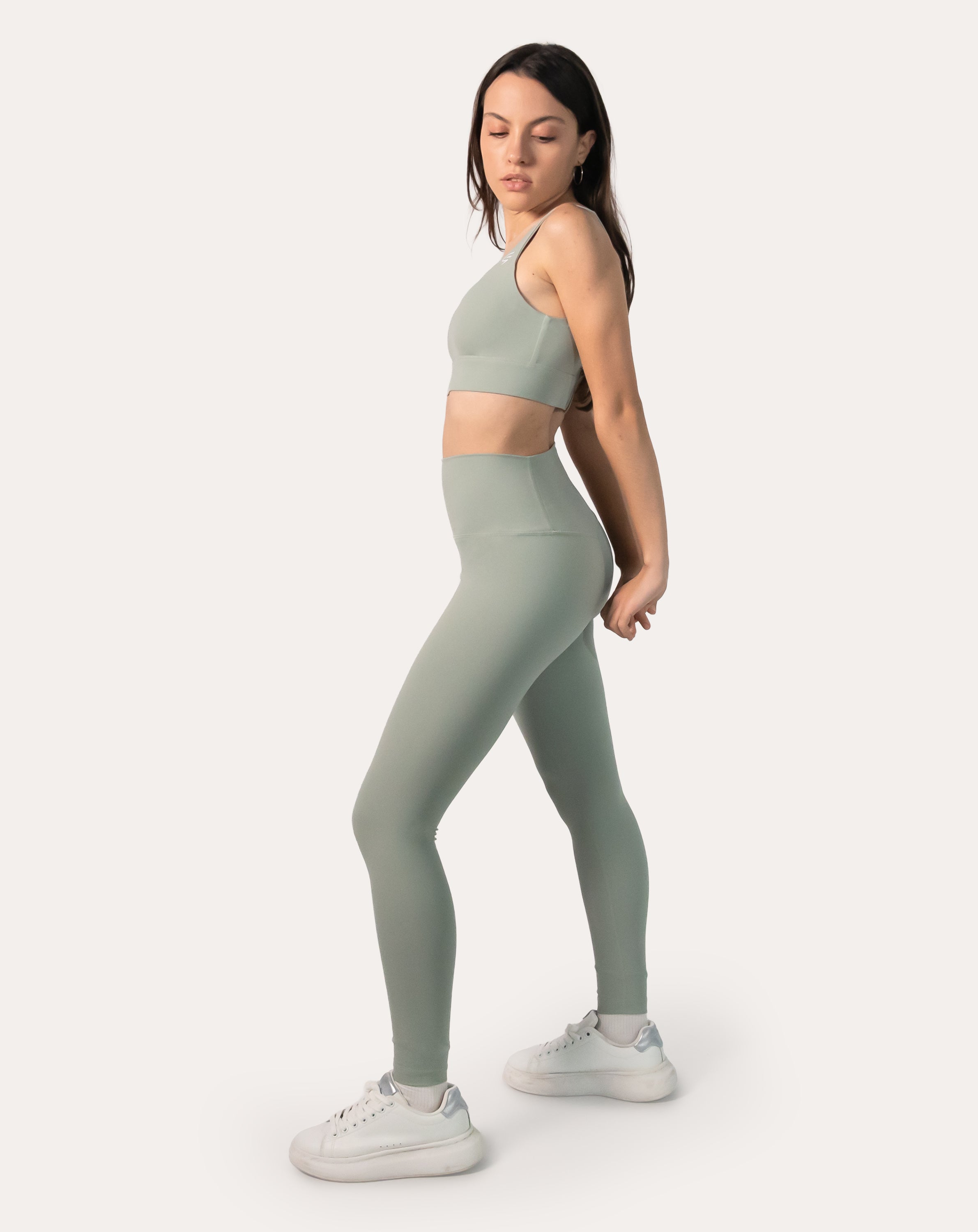 3/4 side pose of sage green gym set with high-rise leggings and second-skin finish