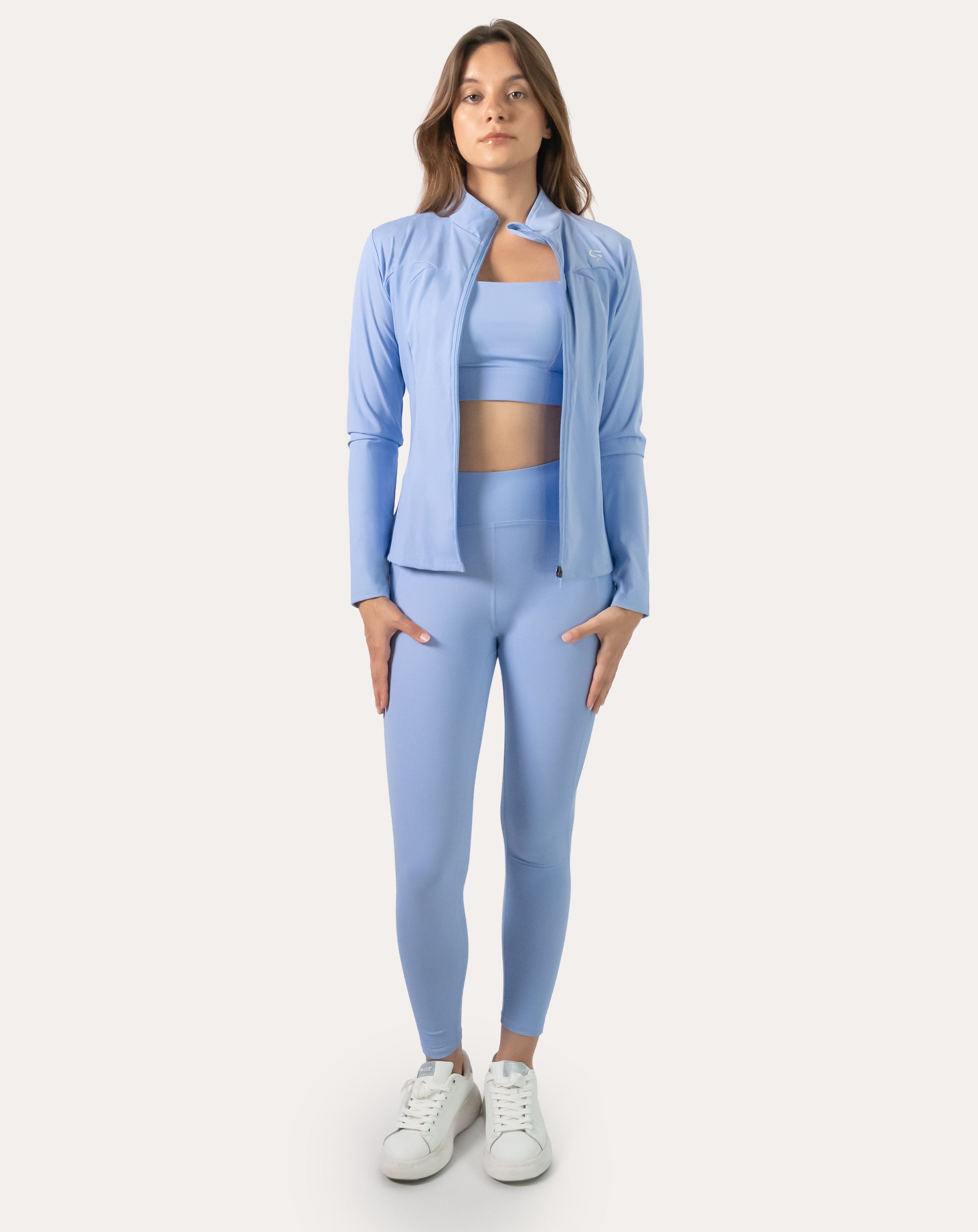 Light blue seamless gym leggings with V-contour high waistband; front view styled with hoodie