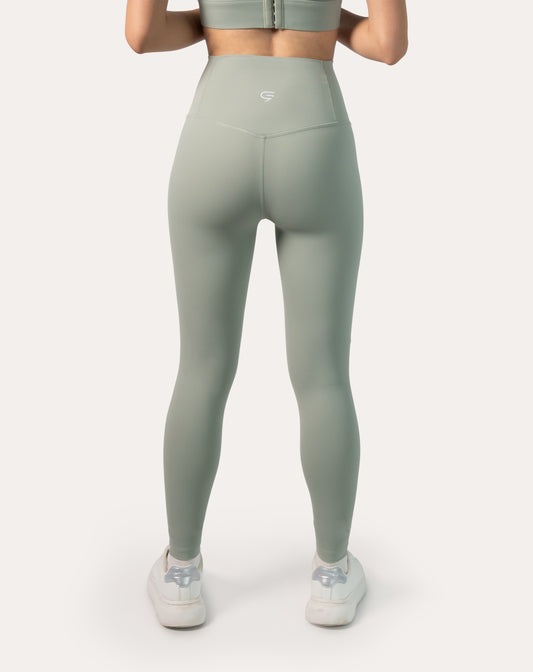 Back view showing the high-rise waistband and contour seams of women’s sage green seamless leggings; ankle-length, gym ready
