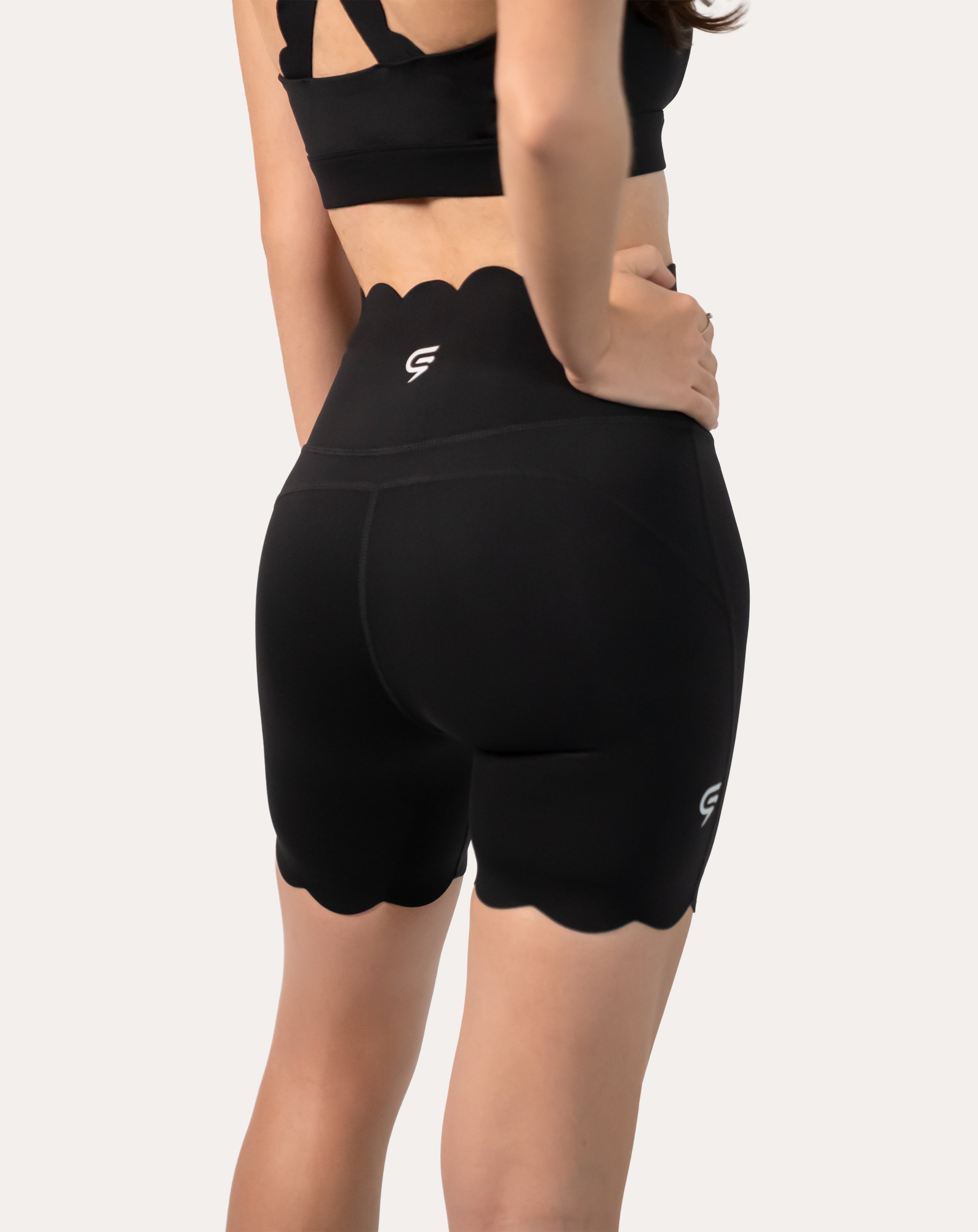 Back close-up of high-waist shorts from black gym shorts set with scalloped hem