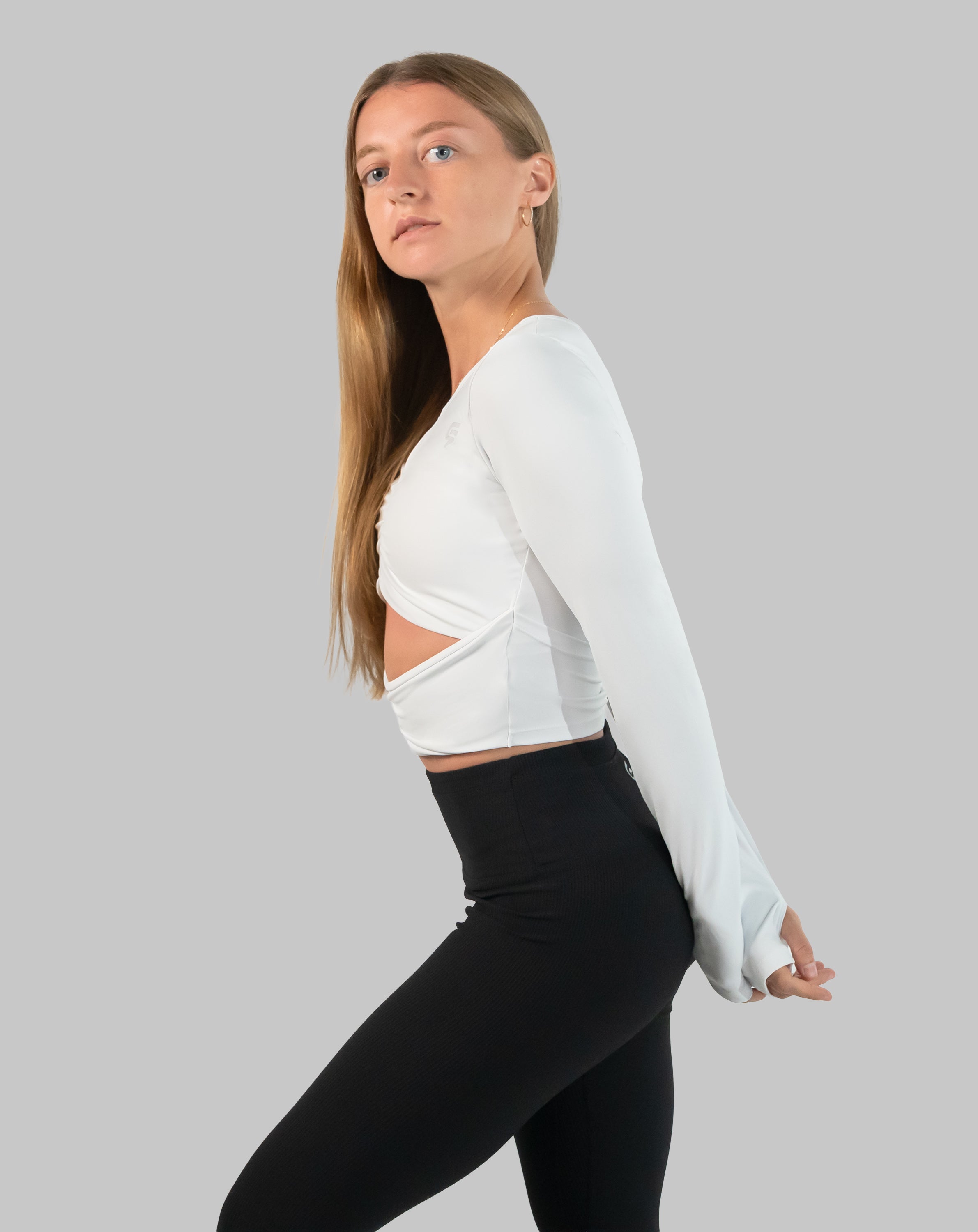 White gym top three-quarter back with arms behind, showing back cut-out and crop length