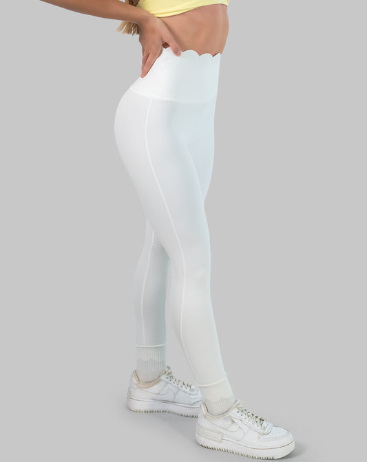 White leggings with high waisted scallop waistband, ankle length; left side view