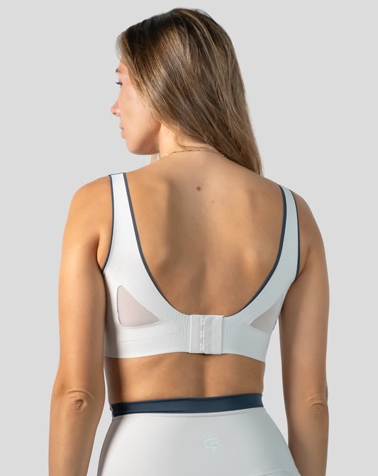 White seamless sports bra full back view with mesh U-back and adjustable hook-back
