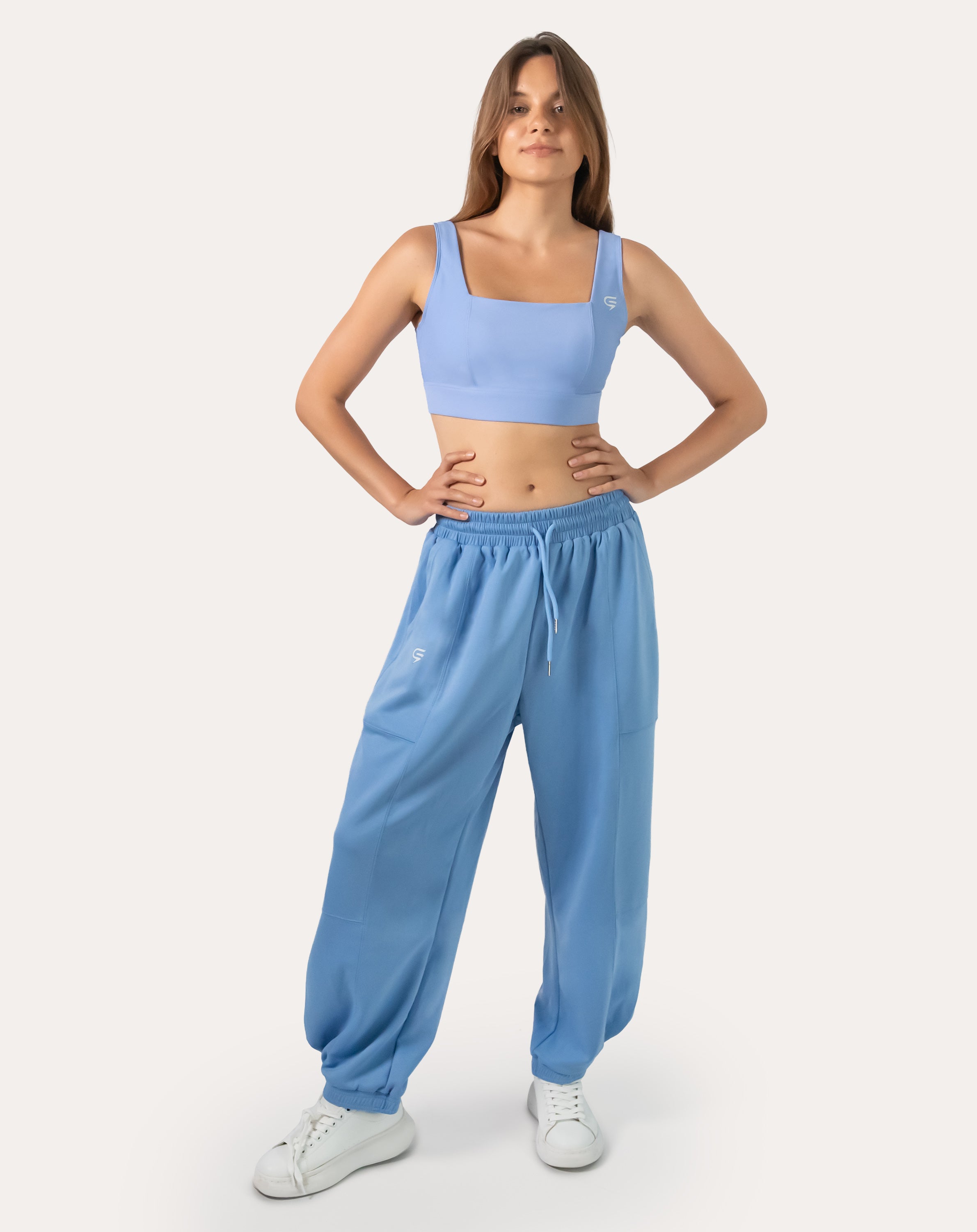 Front view of sky blue women’s gym joggers with high waist and tapered legs