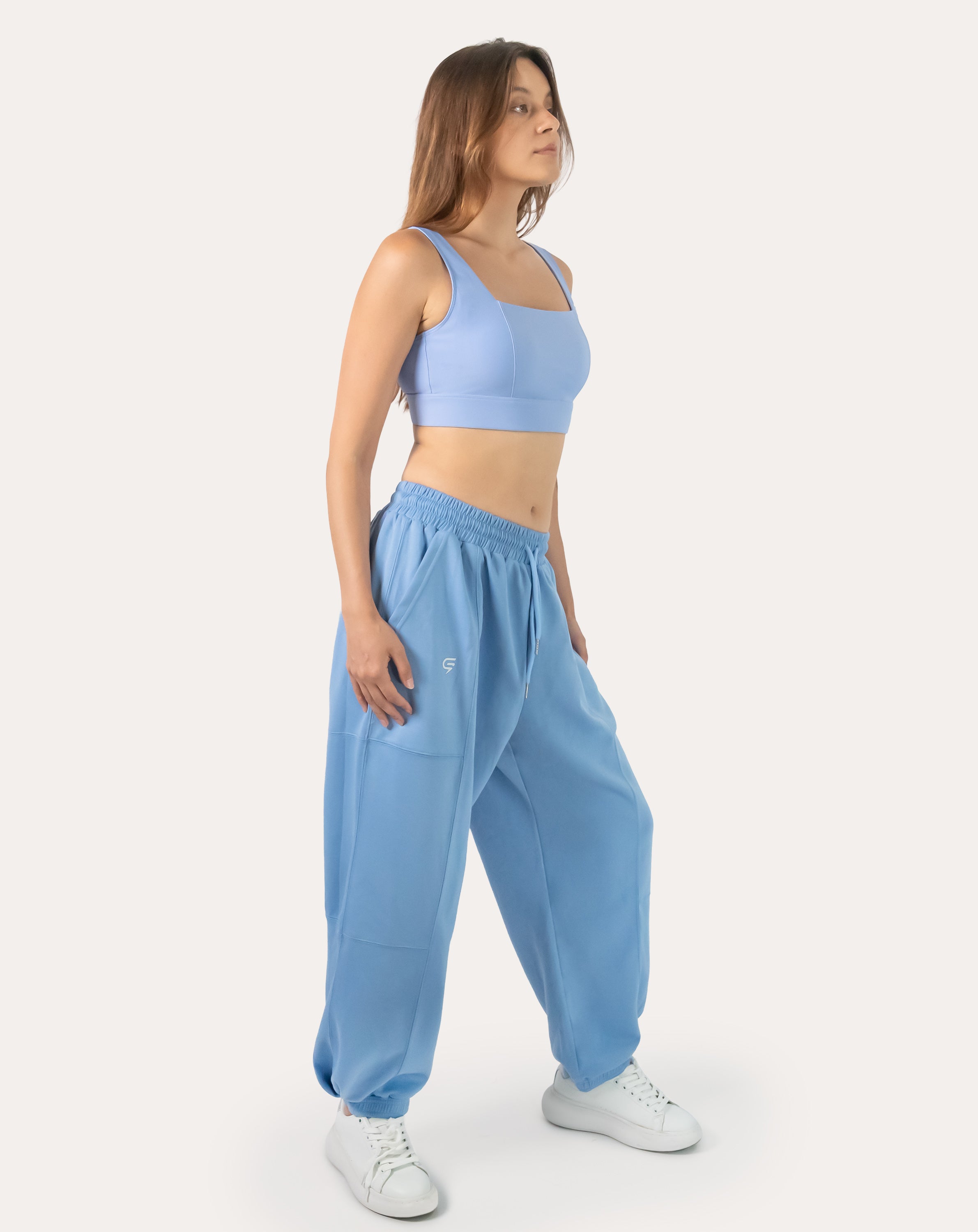 Sky-blue women’s gym joggers, right three-quarter view with oversized, baggy silhouette