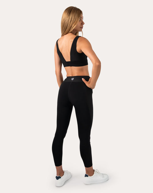 Black womens gym set back view highlighting V-back straps and high-waist leggings