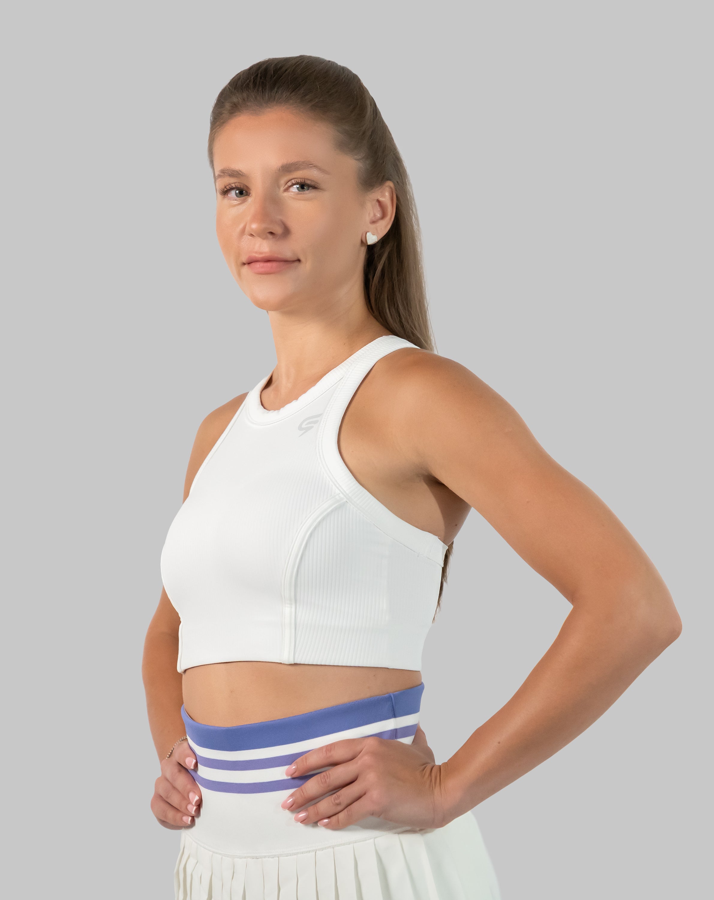 Women’s tennis skirt set in white, side view of pleated mini skirt
