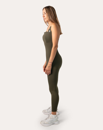 Left-side full-length view of olive athletic jumpsuit for women with sleek tapered legs