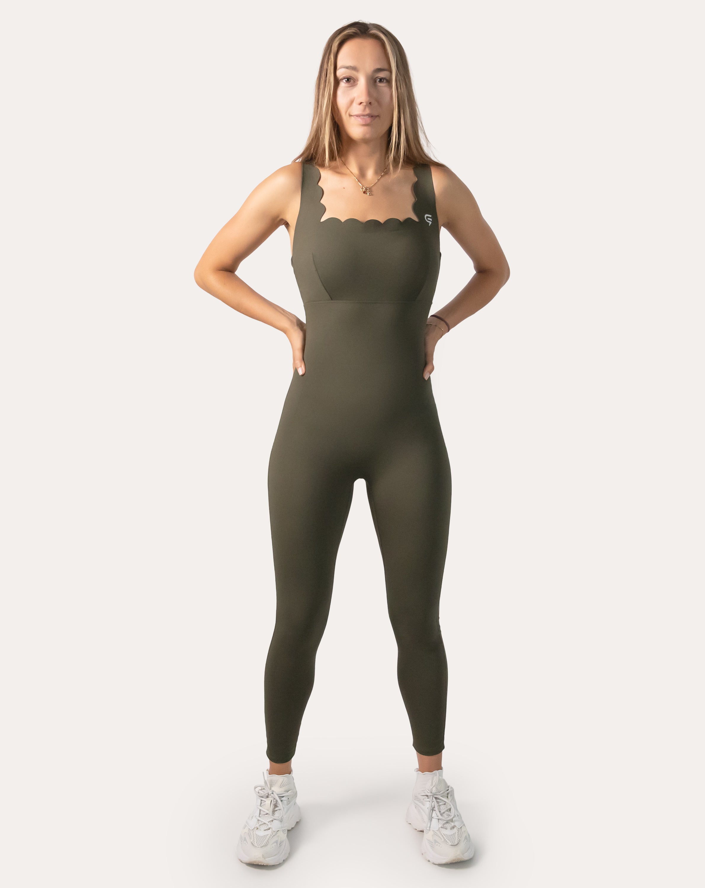 Front view of olive athletic jumpsuit for women with scallop neckline and full-length legs