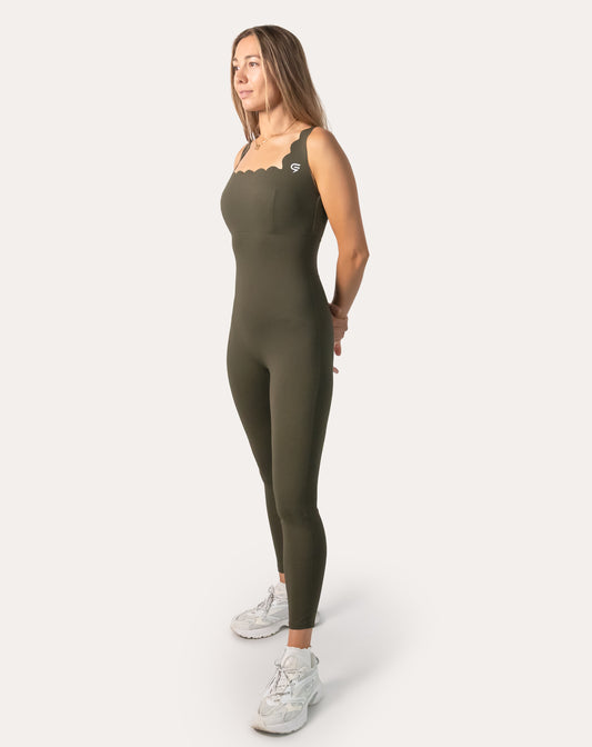 Three-quarter front of olive athletic jumpsuit for women with scallop neck and sculpted fit