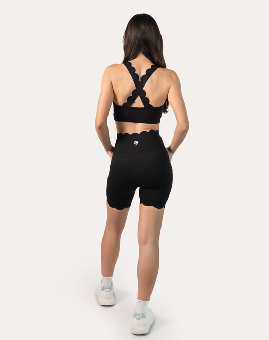 Back view of black gym shorts set highlighting scalloped cross-back straps