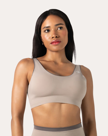 Beige high impact sports bra front close-up with scoop neck and wide straps