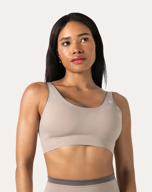 Beige high impact sports bra front close-up with scoop neck and wide straps