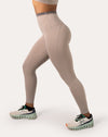 Right side three-quarter angle of beige leggings highlighting sculpted fit and clean seams