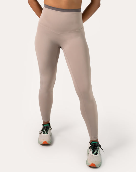 Full-body front view of taupe beige leggings with a sculpting high waist and opaque, squat-proof knit