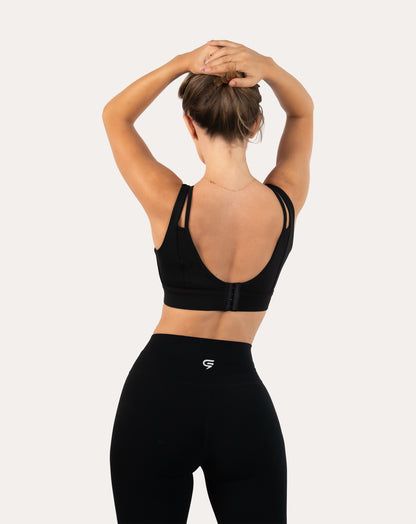 Full-body back view of black flared leggings with clean seams and high-waist band