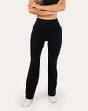 Full-body front view of black flared leggings showing the smooth high waist and bootcut flare