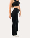 Full-body left side view of black flared leggings with high-waist bootcut silhouette