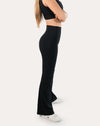 Left side view of black flared leggings emphasizing the sculpting high waist and bootcut