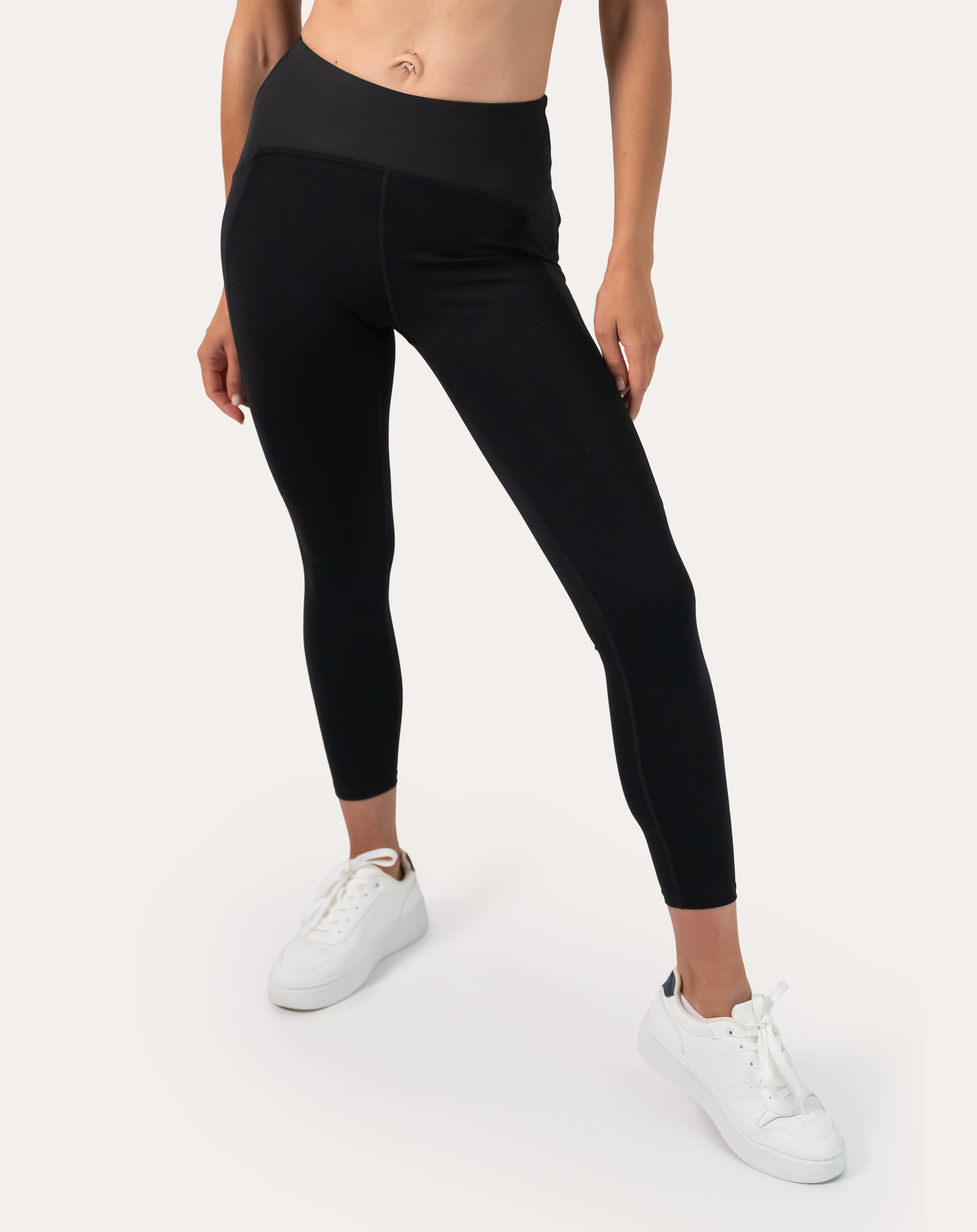 Black gym leggings with high-waist, 7/8 length; front waist-to-ankle close-up