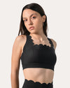 Bra close-up of black gym shorts set showing scalloped neckline and straps