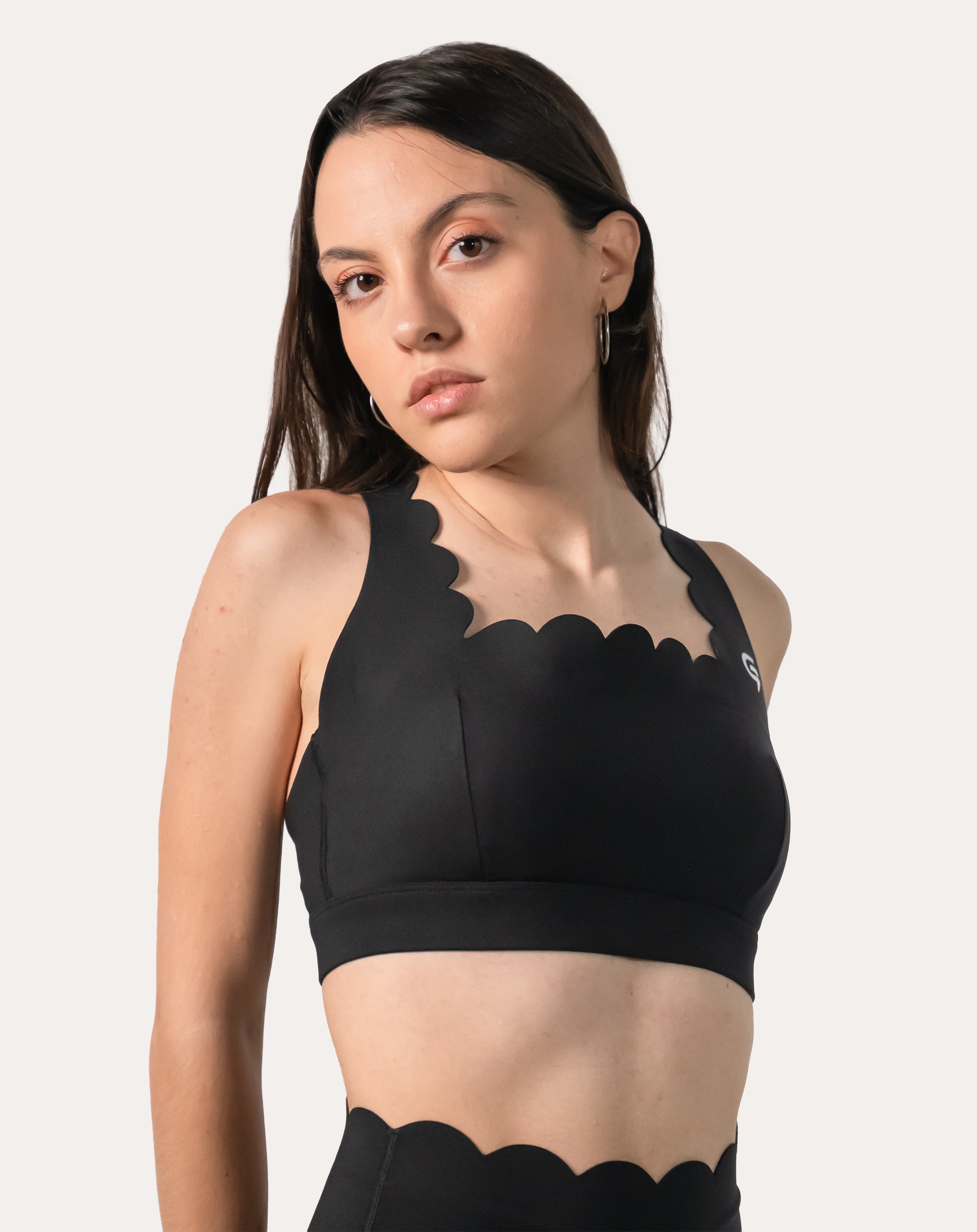 Bra close-up of black gym shorts set showing scalloped neckline and straps