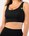 Front close-up three-quarter of black high support sports bra with scoop neck, wide straps and firm underband