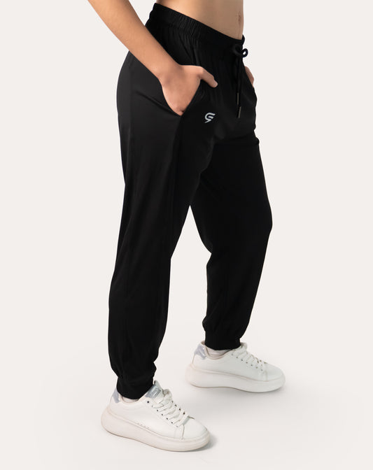 Women’s black joggers, left three-quarter front view with high waist and cuffed ankles