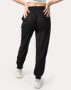 Back full-length view of black joggers for women with elastic waistband and cuffed ankles