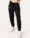 Front full-length view of black joggers for women with tapered legs and cuffed ankles; hands at sides